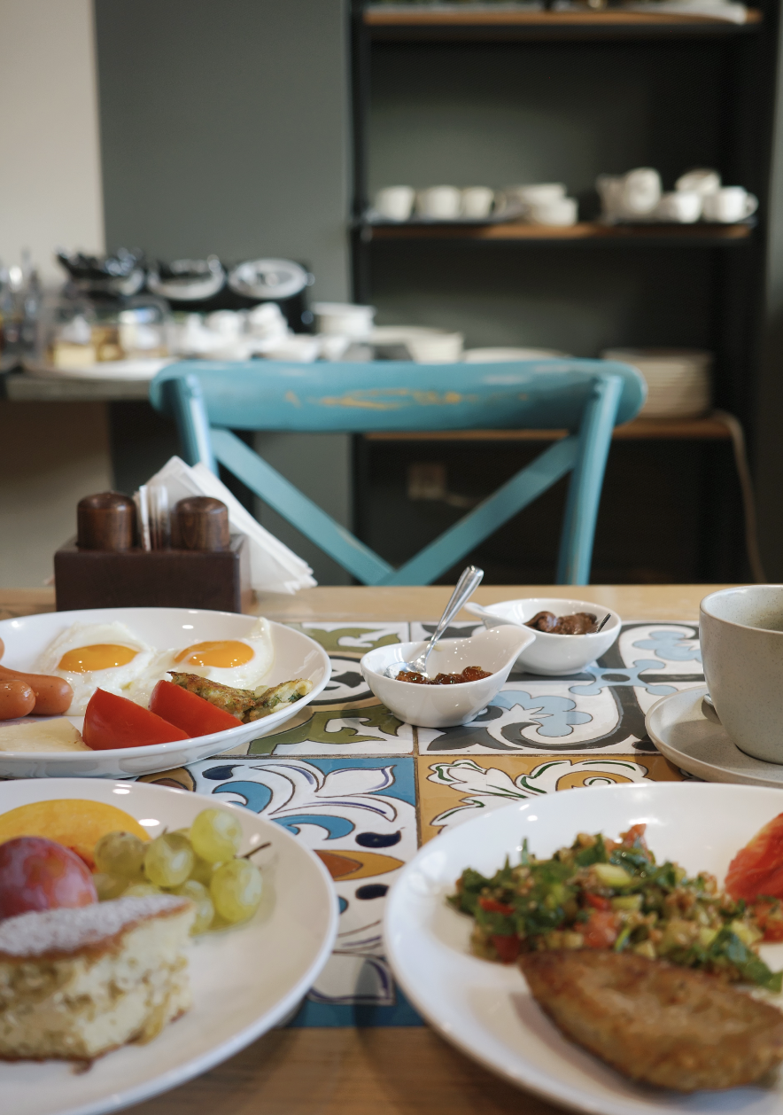 Cartez Brunch table setting with colorful tile placemats and fresh breakfast