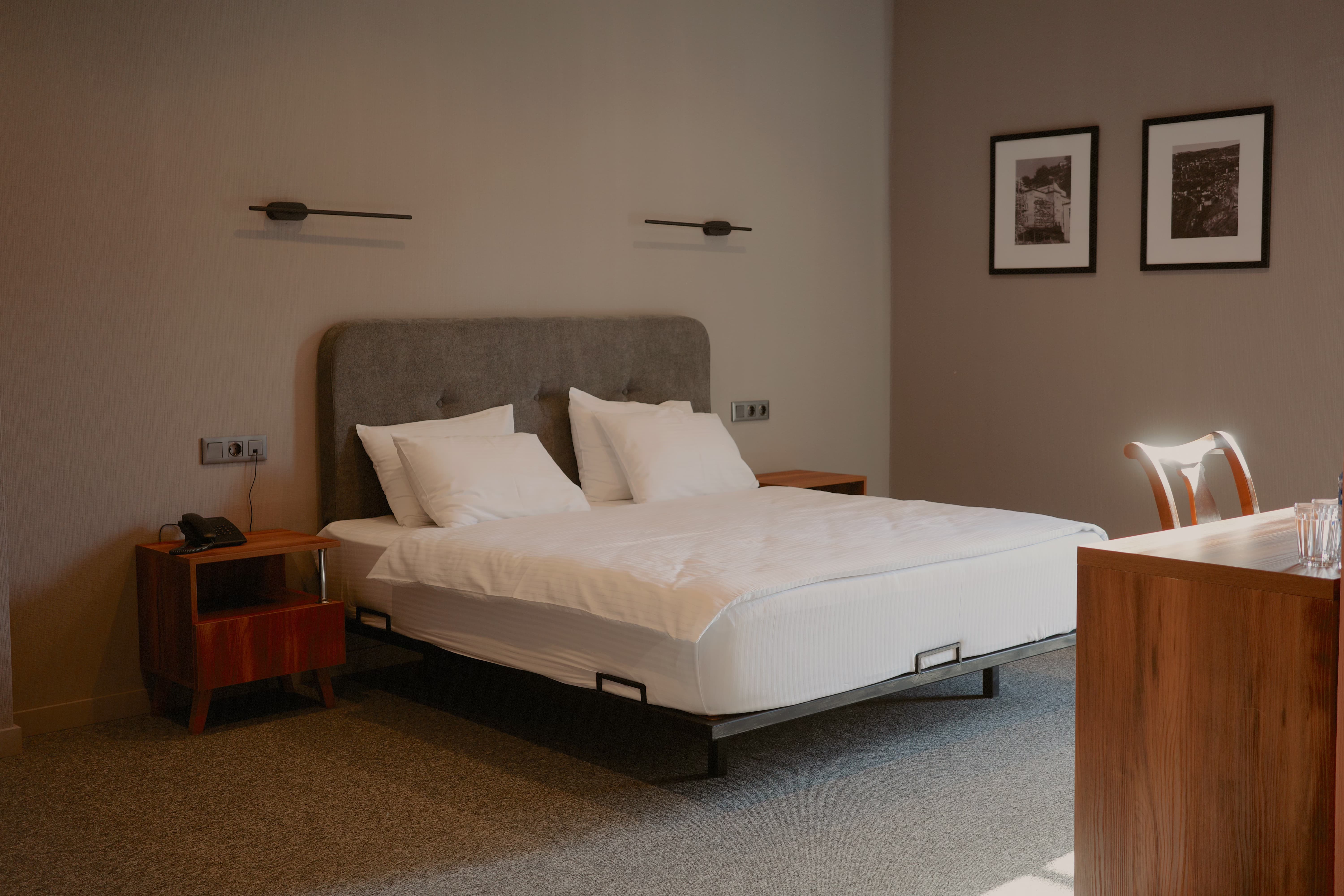 Hotel bedroom with minimalist design and mid-century furniture