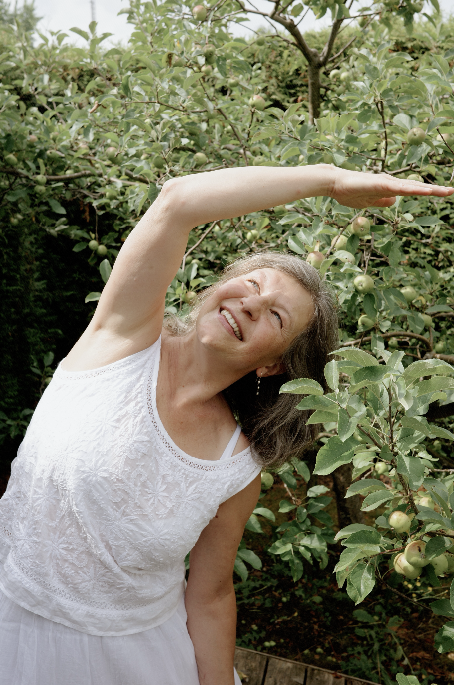 Christina doing side stretch in garden setting