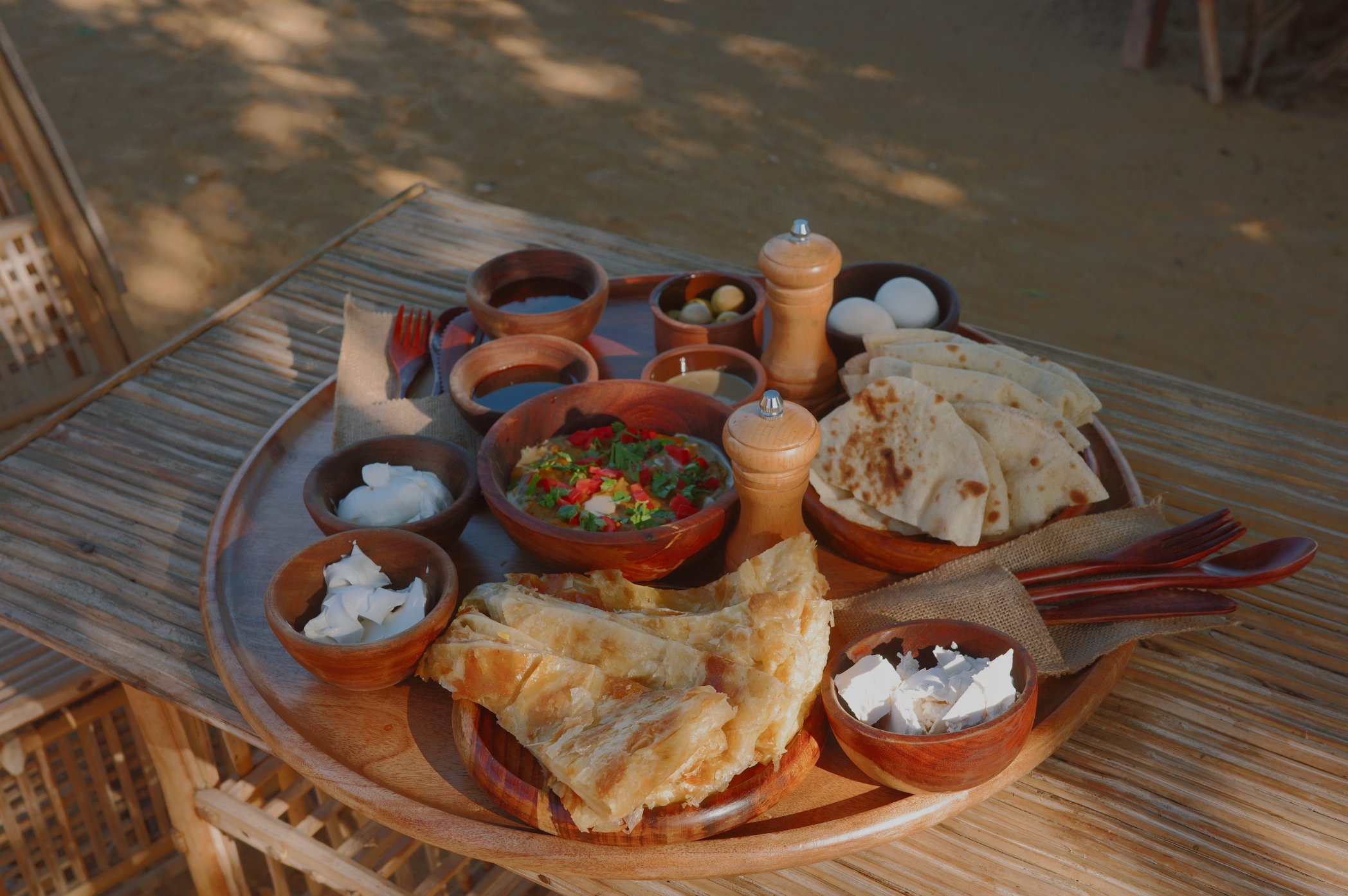 Egyptian breakfast spread with eggs and flatbreads by the pool