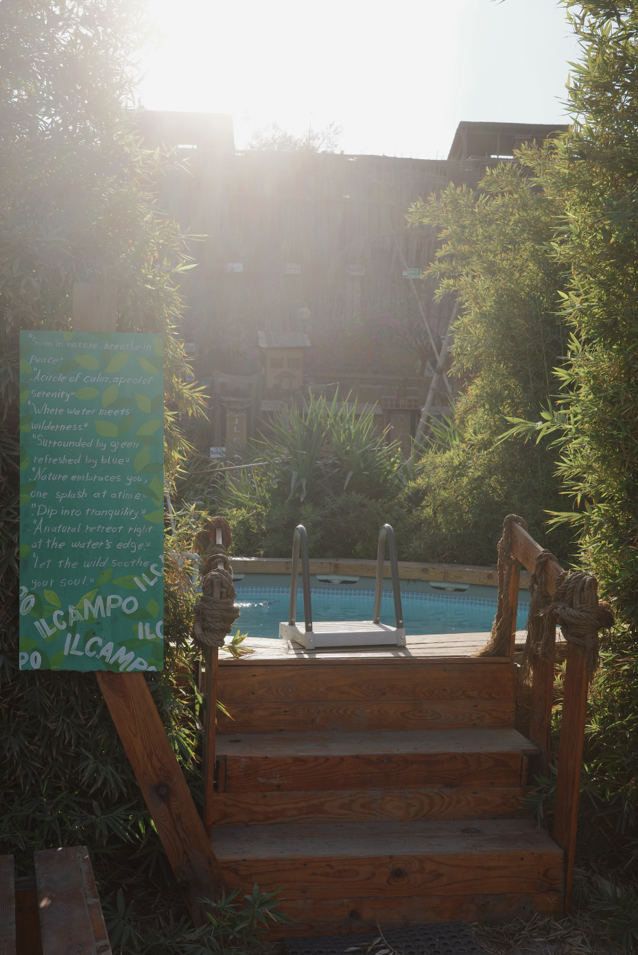 Pool entrance with IL CAMPO signage and wooden stairs