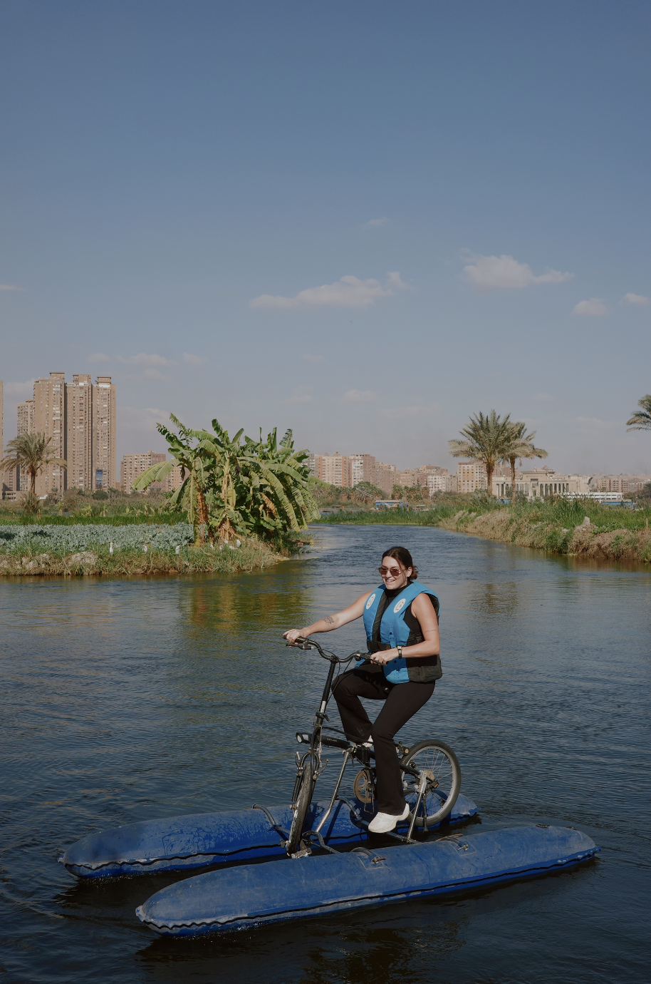 Guest on water bike exploring the Nile with Cairo skyline