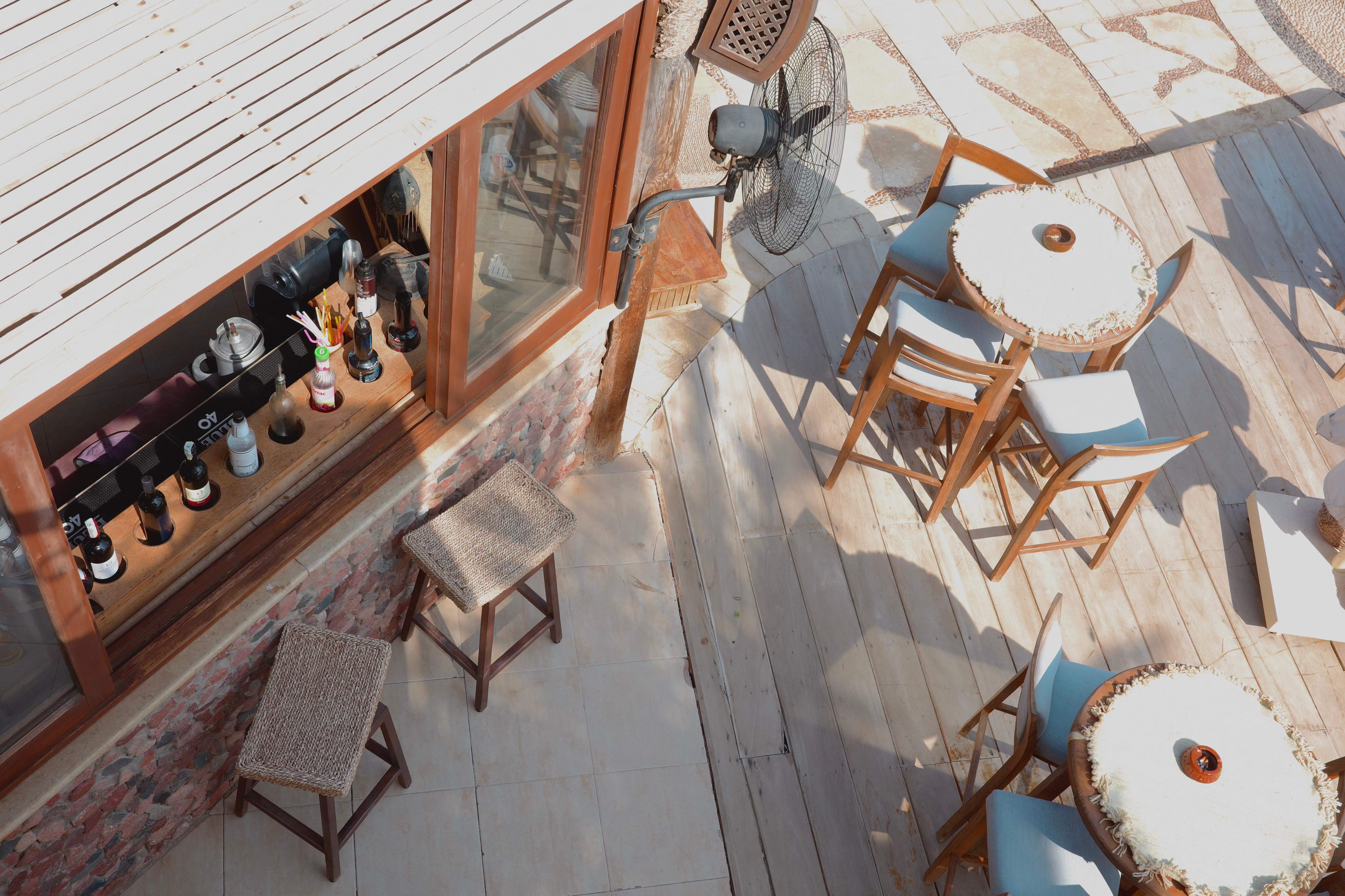 Guest enjoying breakfast on balcony overlooking pool and sea